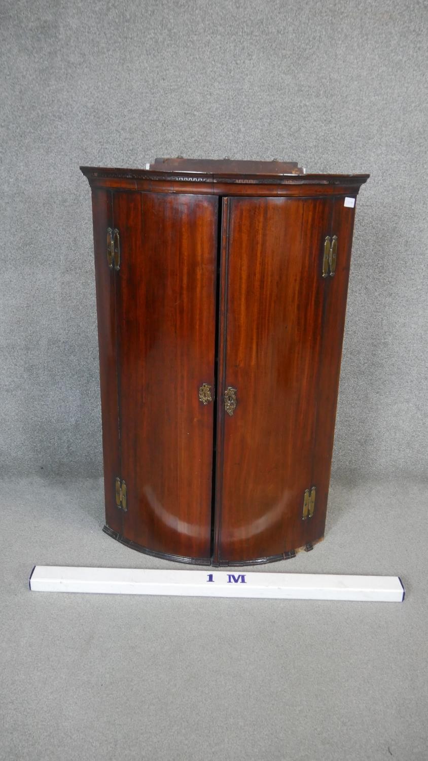 A Georgian mahogany hanging corner cabinet, the bow fronted panel doors enclosing shelves and base - Image 5 of 5