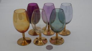 A set of six Bohemian multicolored coloured wine glasses with gilded stems, six different colours