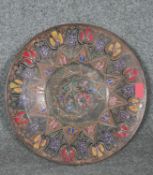 An Dutch Indonesian engraved bronze plate with engraved stylised floral design and central medallion