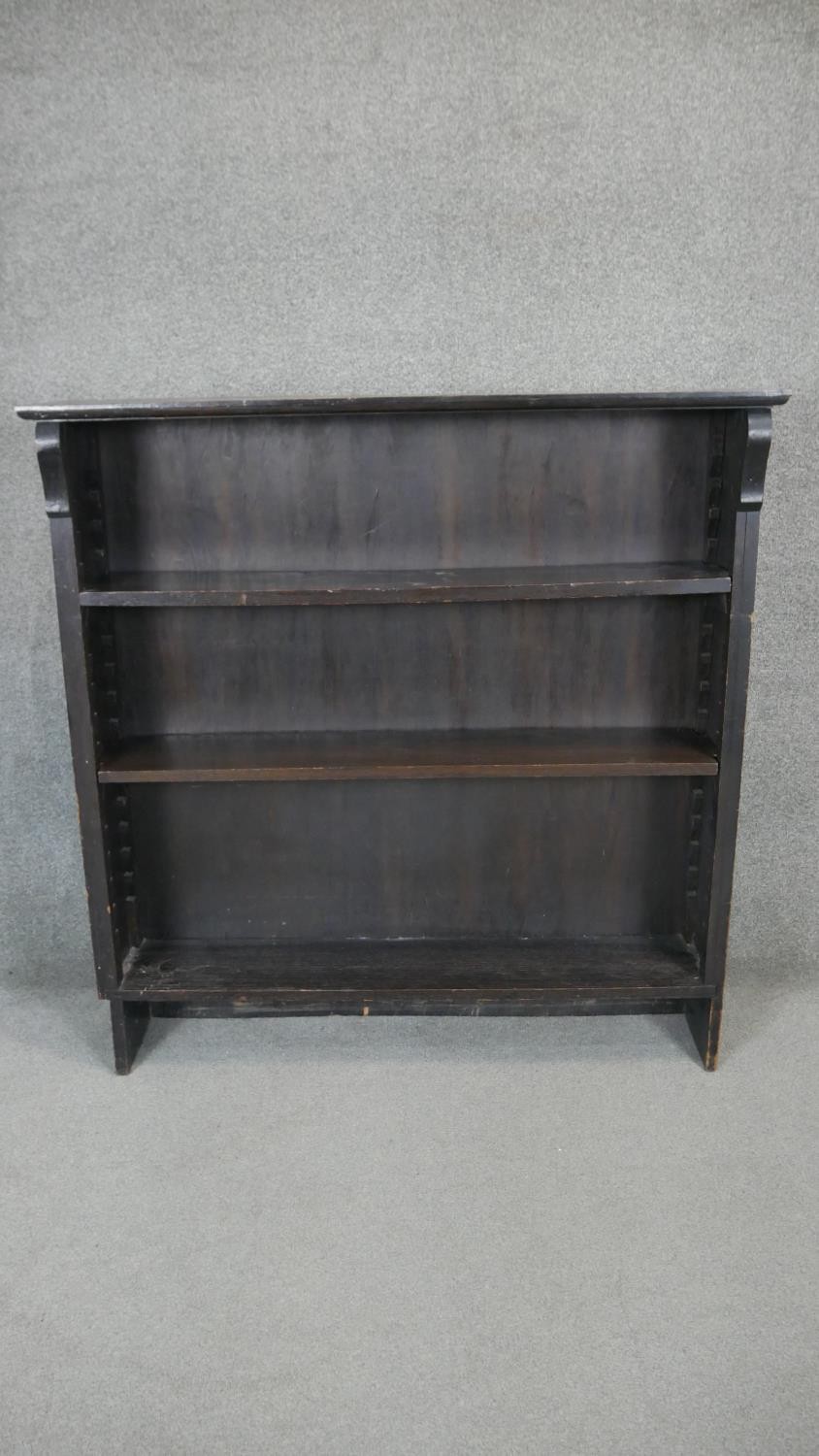 An ebonised open bookcase with adjustable shelves. H.120 W.117 D.26cm