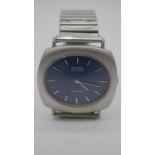 A vintage CYMA by Synchron, Chambord steel swiss watch with stretch strap and dark blue dial.