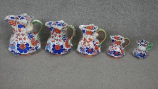 Set of five 18th century Mason's Ironstone blue and red floral design graduating jugs. H.25 (