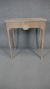 A mid century limed oak early Georgian style side table with inlaid roundel to the frieze drawer