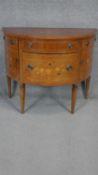 A Continental style demi lune commode with floral satinwood inlay with crossbanding and stringing to