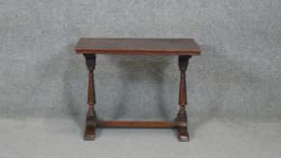 A mid century oak Jacobean style coffee table on stretchered supports. W52 H37 D40
