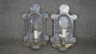 A pair of 19th century pewter wall sconce/candle clocks converted to electric lights, with