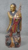 A large early 20th century East Asian carved gilded and painted wooden buddha statue. With