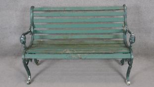 A vintage painted iron garden bench with slatted seat. H.84 x W.125 x D.64cm