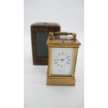 A brown leather cased Georgian gilt bronze and bevelled glass carriage clock by Whitehead & Sons,