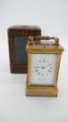 A brown leather cased Georgian gilt bronze and bevelled glass carriage clock by Whitehead & Sons,
