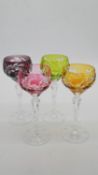 A set of four Bohemian cut to clear foliate and floral design coloured glasses with cut bases.