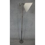 A vintage brass and iron adjustable standard reading lamp with conical glass shade. H.145cm