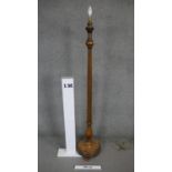 A mid century carved walnut lamp standard with reeded column on platform base. H.166cm