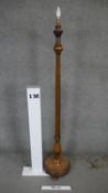 A mid century carved walnut lamp standard with reeded column on platform base. H.166cm