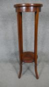 An Edwardian mahogany and satinwood inlaid jardiniere stand on swept supports united by undertier.
