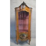 A gilt metal mounted and glazed kingwood vitrine in the Louis XV taste with Rococo cresting above