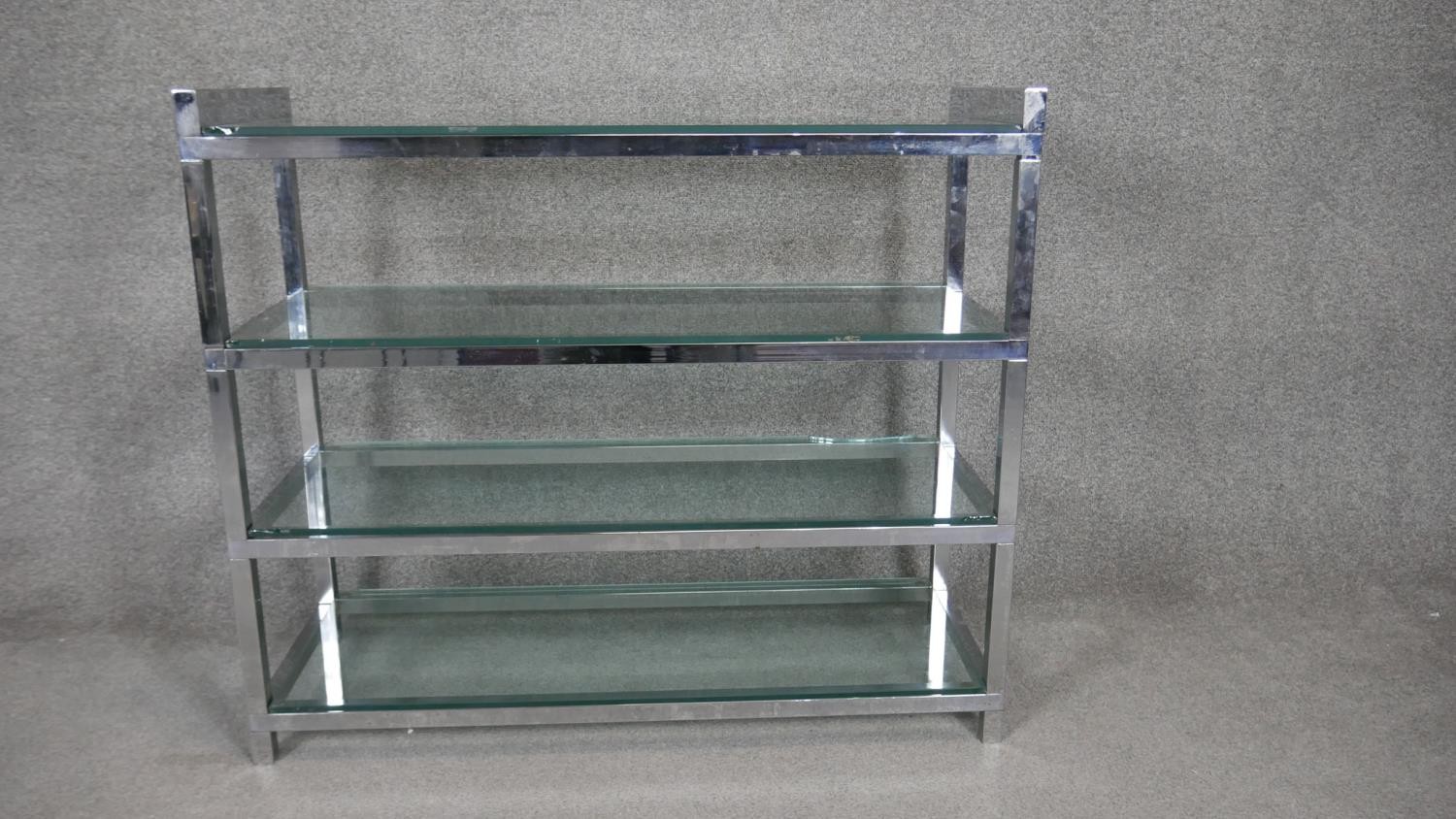 A vintage style chrome framed four tier etagere with plate glass shelves. H.84 W.97 D.36cm