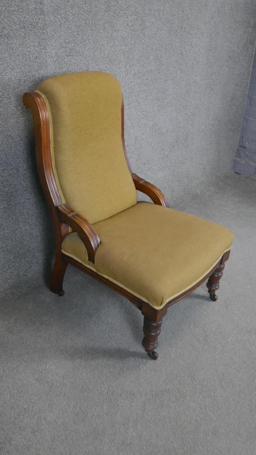 A Victorian walnut upholstered nursing chair on turned tapering supports. - Image 2 of 3