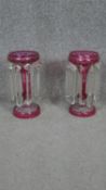 A pair of 19th century Bohemian cranberry etched glass mantle lustres with crystal drops and