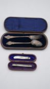 A leather cased set of silver spoon and fork with engraved floral pattern by George Unite,