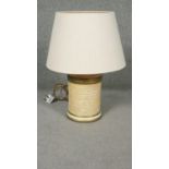 A John Lewis paper effect ceramic cylindrical table lamp with calligraphy and gilded details. Makers