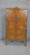 A mid century burr walnut Epstein drinks cabinet with mirrored back and sycamore lined, fitted and