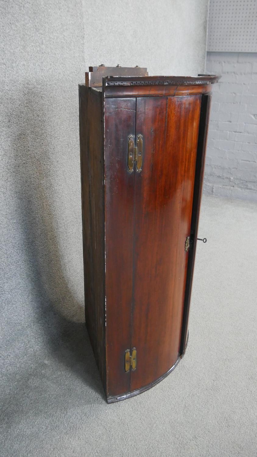 A Georgian mahogany hanging corner cabinet, the bow fronted panel doors enclosing shelves and base - Image 3 of 5