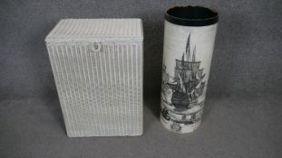A Lusty LLoyd Loom linen basket and a laminated card and overprinted umbrella stand. H.60cm Dia.23cm