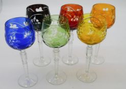 A set of six Bohemian cut to clear coloured wine glasses with vine and grape design and faceted