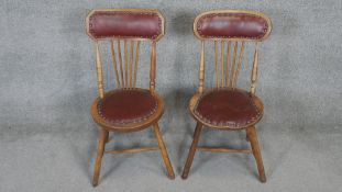 A pair of late 19th century oak stick back chairs.