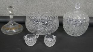 A large cut crystal punch bowl with two punch cups, a lidded crystal bowl and gilded crystal