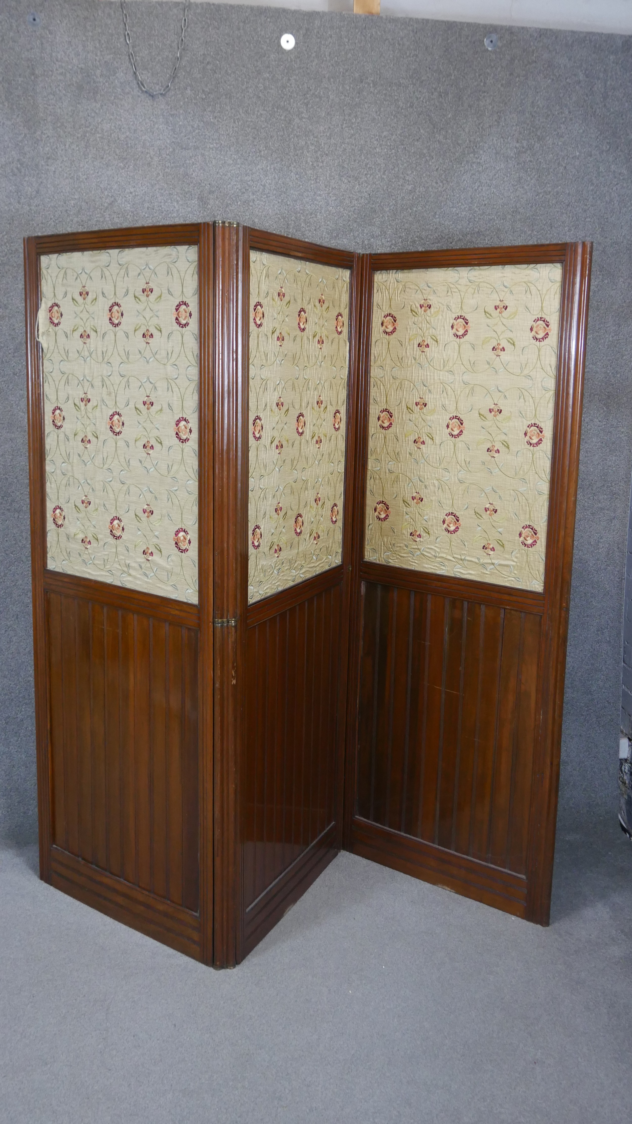 A late 19th century walnut two fold three panel room divider with inset floral tapestry panels. H.