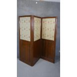 A late 19th century walnut two fold three panel room divider with inset floral tapestry panels. H.