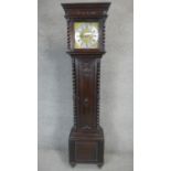 An oak cased longcase clock with eight day movement and brass and steel dial with weights and