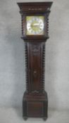 An oak cased longcase clock with eight day movement and brass and steel dial with weights and