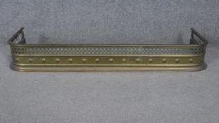 A Victorian pierced brass fender. W.103cm