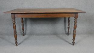A 19th century oak planked top refectory table on turned supports. H.77 W.1567 D.77cm