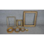 A collection of seven antique carved gilt frames. Including four round frames, one with foliate