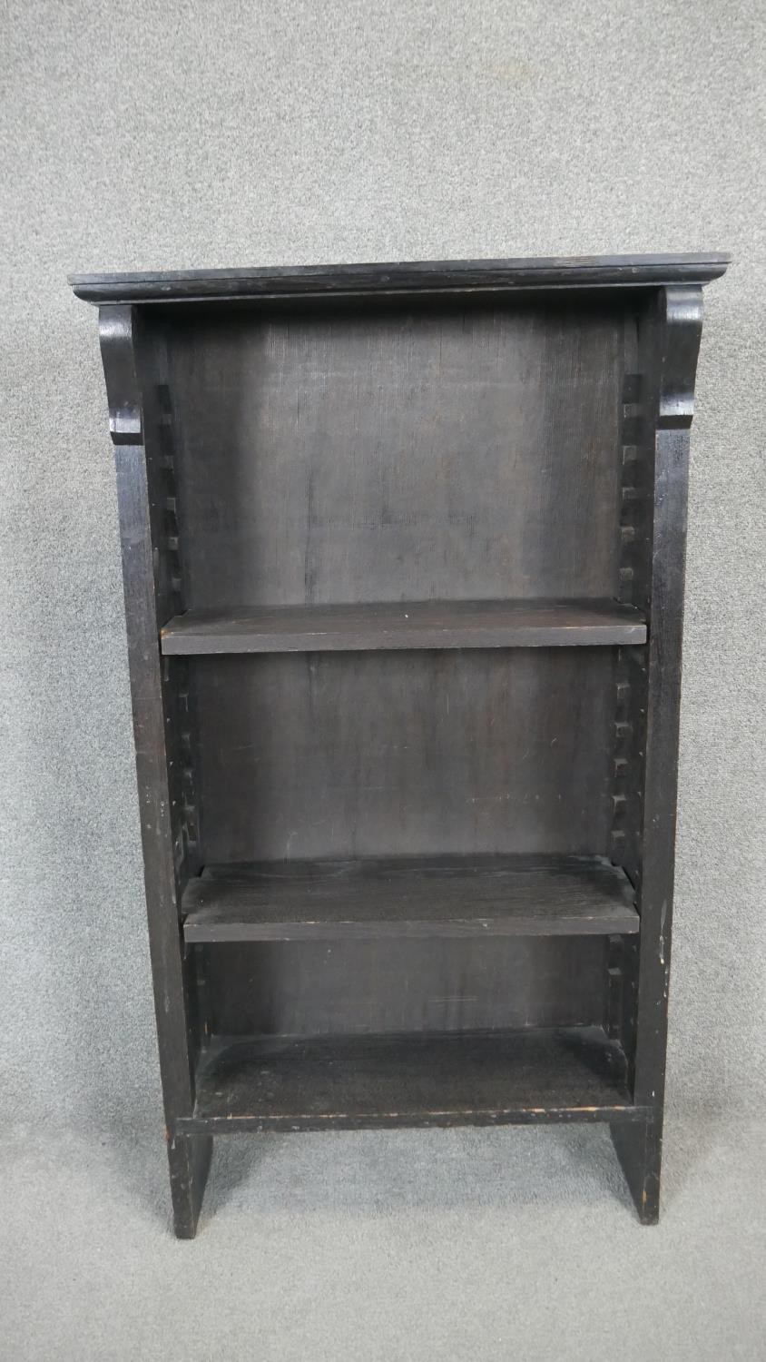 An ebonised open bookcase with adjustable shelves. H.120 W.70 D.26cm