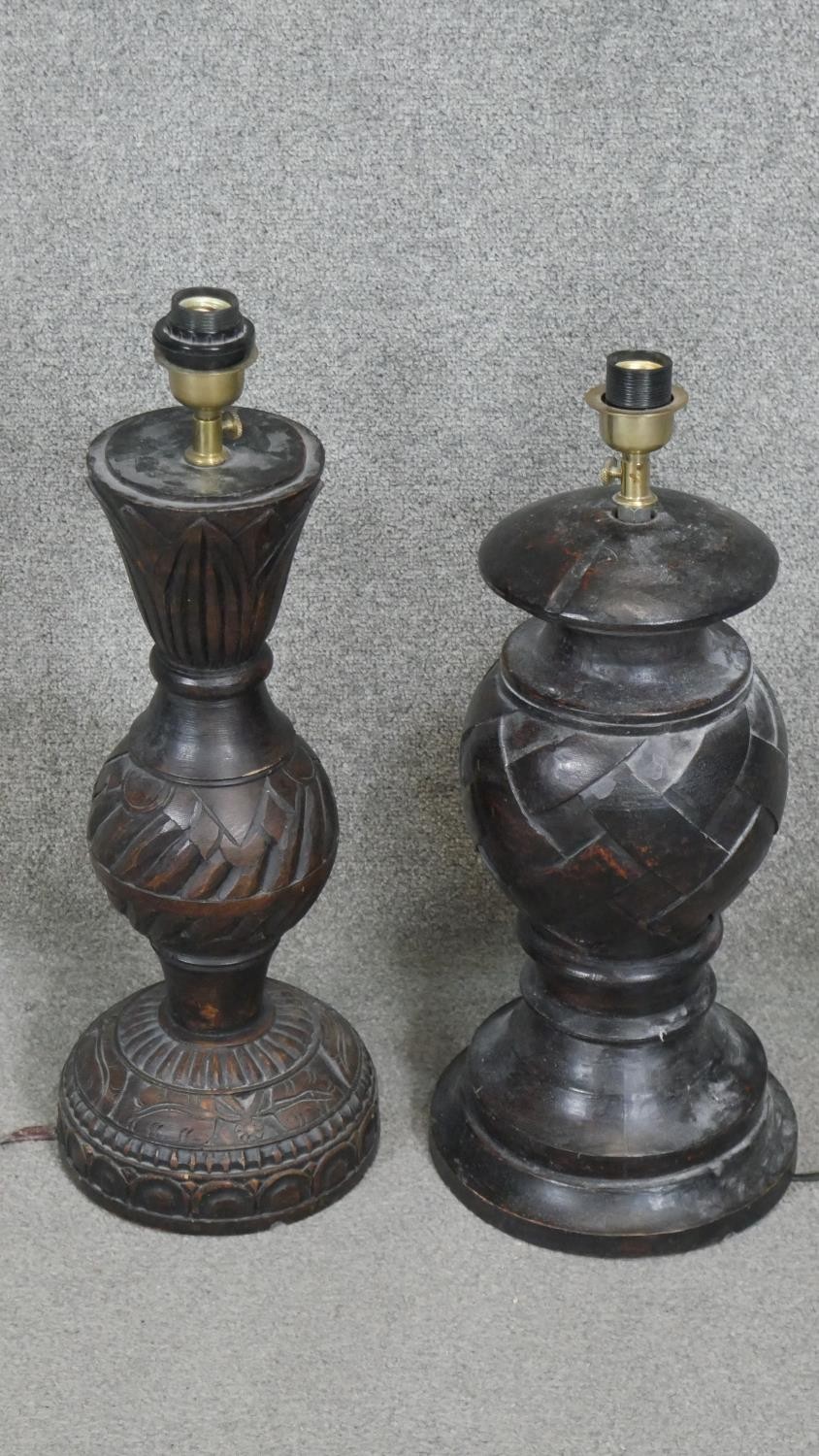Two carved and stained table lamps with geometric design.H.60CM