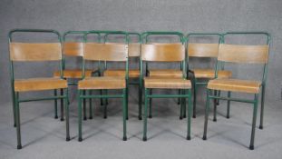 A set of eight vintage metal framed and laminated ply stacking chairs by Remploy.