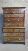 A Georgian flame mahogany chest on chest with stepped cornice above an arrangement of drawers on