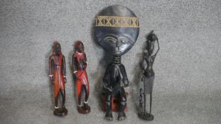 Four carved African hardwood tribal figures. H.50cm (Tallest)