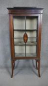 An Edwardian mahogany and inlaid display cabinet on swept supports. H.150 W.48 D.30cm