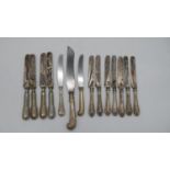 A collection of fourteen silver and silver plated handled knives. Including a carving knife. Various