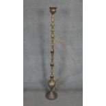 A floor standing middle Eastern brass smokers hookah with engraved floral and foliate design. H.