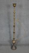 A floor standing middle Eastern brass smokers hookah with engraved floral and foliate design. H.