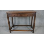 A mid century oak Jacobean style side table with carved frieze drawers on square stretchered