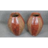 Two ovoid terracotta effect ceramic vases with coloured banding. H.49CM