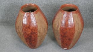 Two ovoid terracotta effect ceramic vases with coloured banding. H.49CM